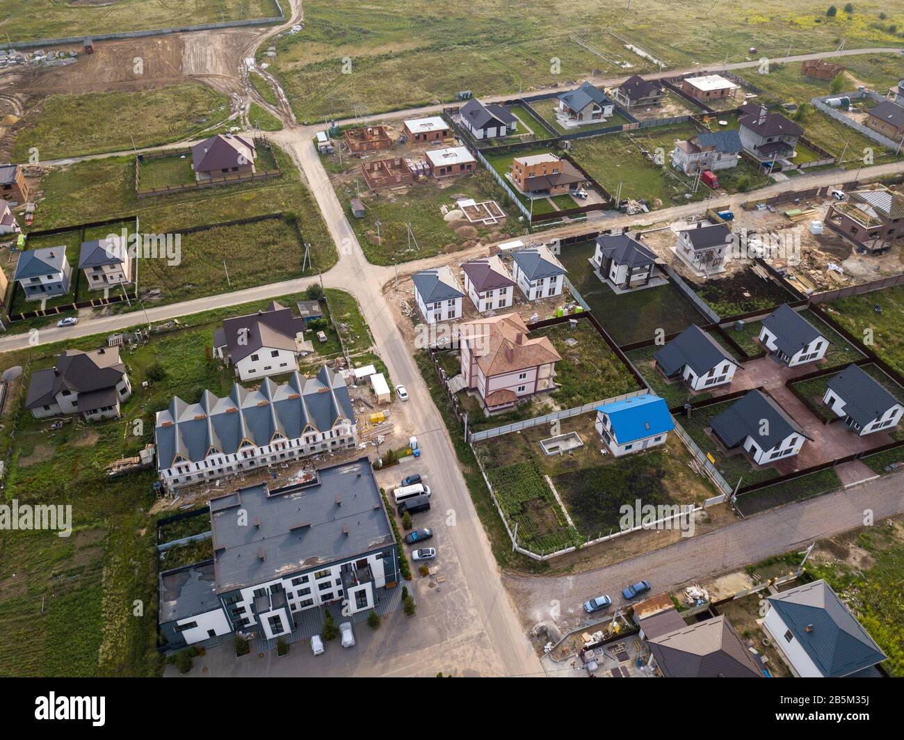 Aerial view of the village against the background of the far-sighted city on a summer day Stock Photo