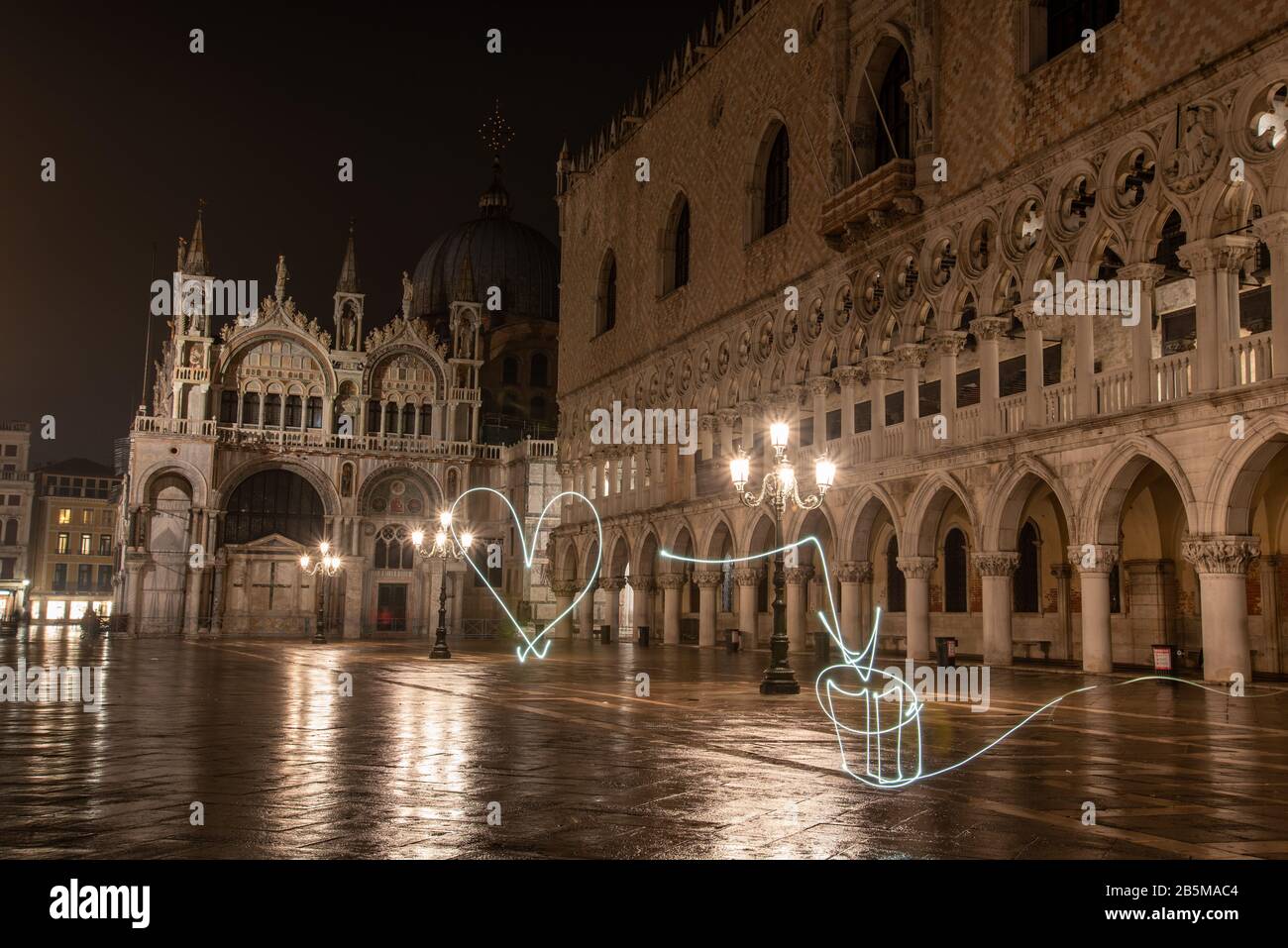 Writing with Light in front of the Illuminated Doge Palace on the Marks Square at Night, Venice/Italy Stock Photo