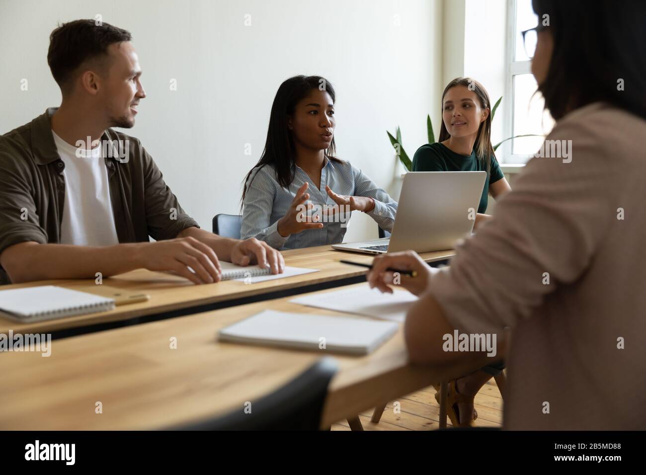 Multiracial businesspeople brainstorm share ideas at briefing Stock Photo