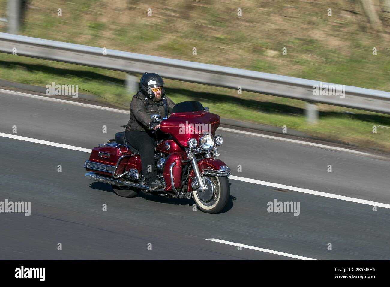 harley davidson motorbike and rider riding on the M6 motorway near Preston in Lancashire, UK Stock Photo