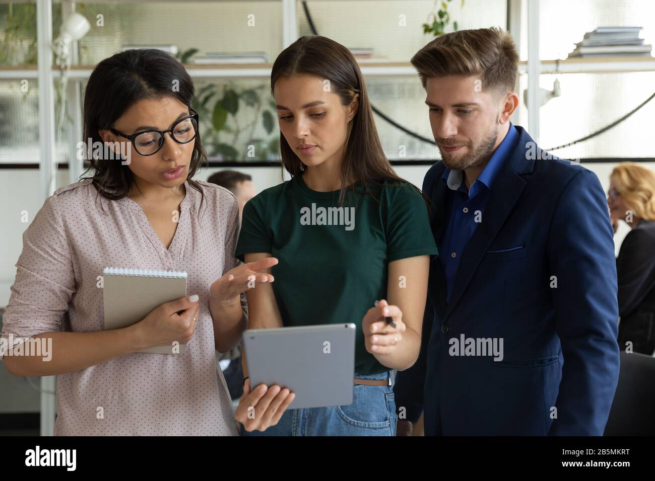 Multiracial coworkers brainstorm discussing ideas in office Stock Photo ...