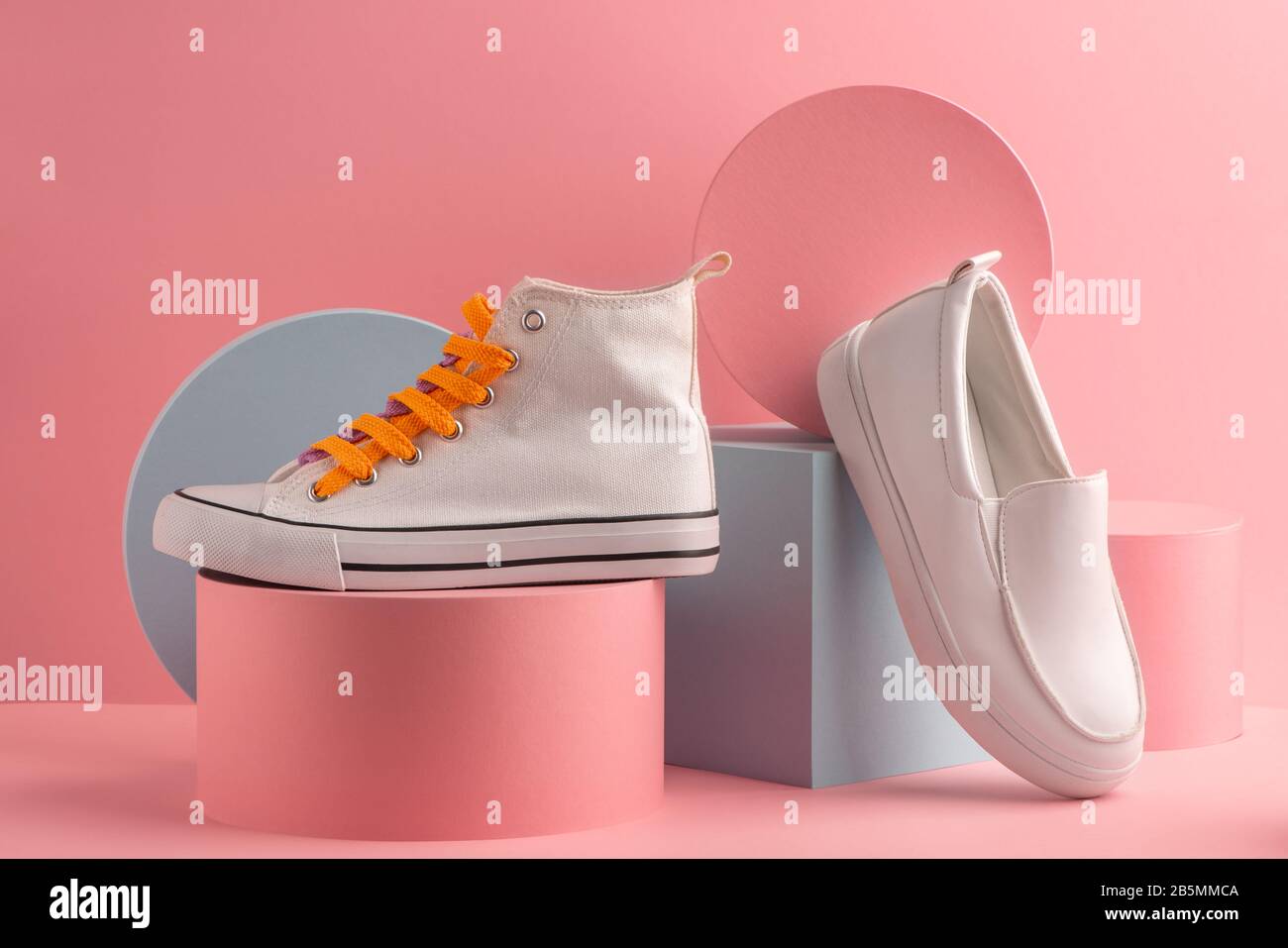 White sneaker and loafer on pink background Stock Photo