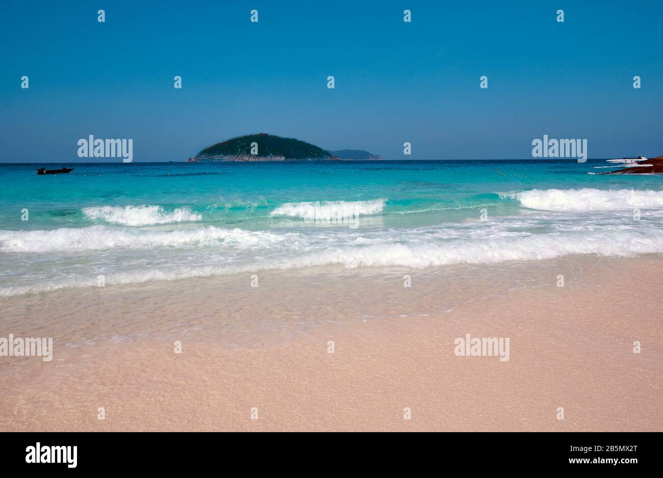 beautiful beach and tropical sea with a rolling wave Stock Photo