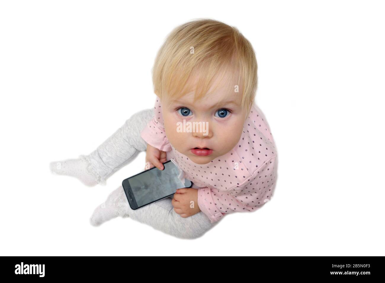 child is holding a cell phone Stock Photo