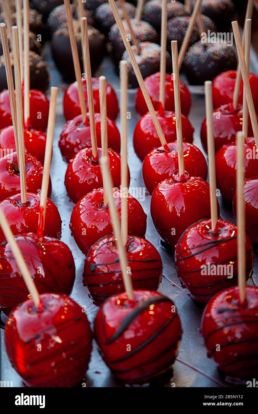 Sweet glazed red toffee candy apples on sticks stock photo stock photo Stock Photo