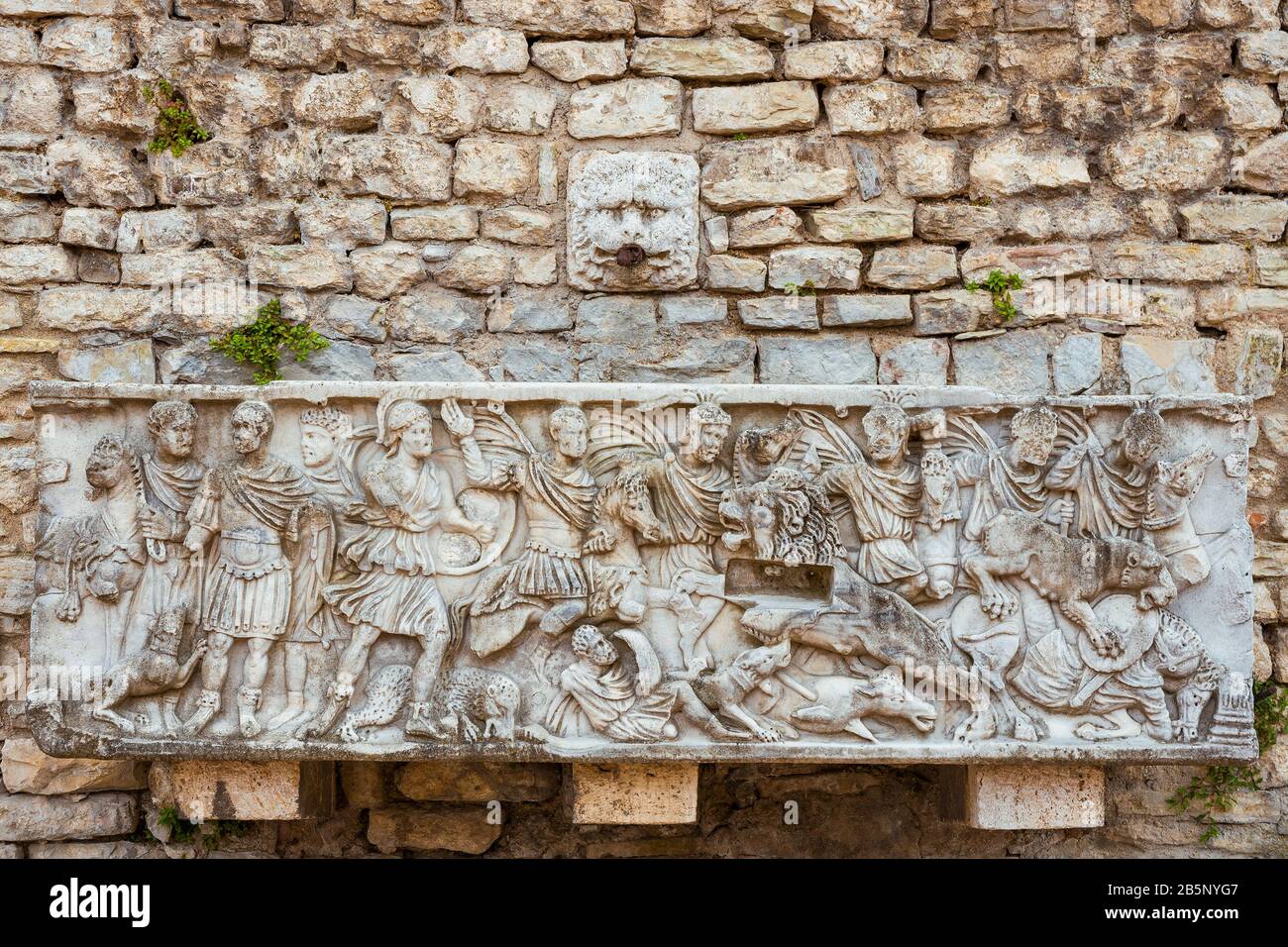 Old fountain with ancient roman reliefs in Spoleto Cathedral Square Stock Photo