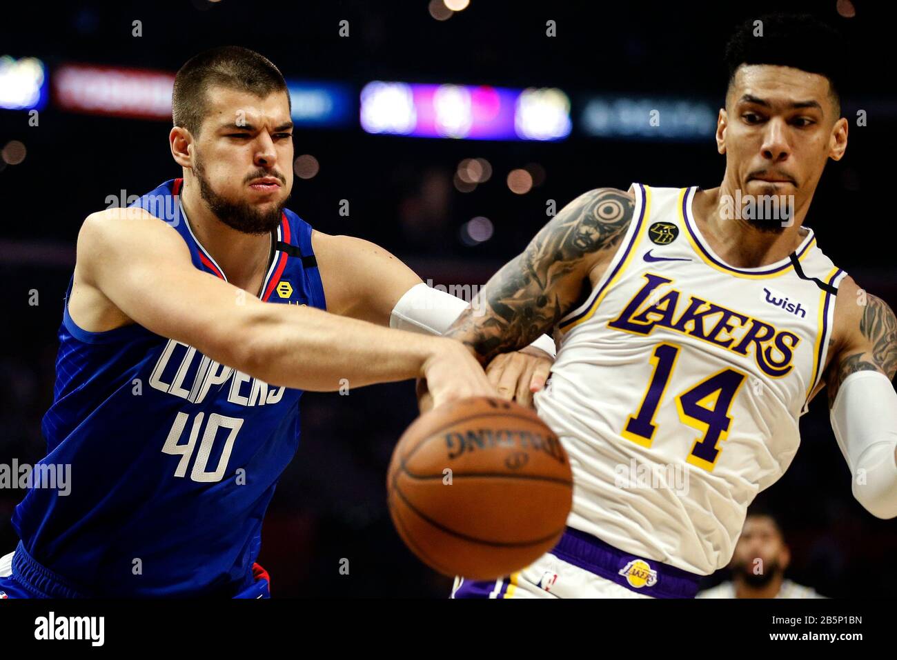 Los Angeles, California, USA. 8th Mar, 2020. Los Angeles Lakers' Danny Green (14) and Los Angeles Clippers' Ivica Zubac (40) fight for the ball during an NBA basketball game between the Los Angeles Clippers and Los Angeles Lakers, Sunday, March 8, 2020, in Los Angeles. Credit: Ringo Chiu/ZUMA Wire/Alamy Live News Stock Photo