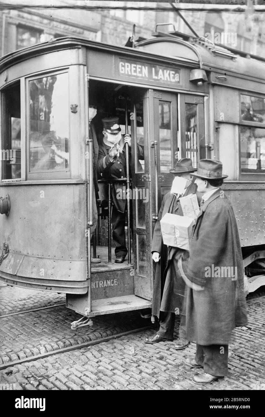Precautions taken in Seattle, Wash., during the Spanish Influenza Epidemic would not permit anyone to ride on the street cars without wearing a mask. 260,000 of these were made by the Seattle Chapter of the Red Cross which consisted of 120 workers, in three days Stock Photo