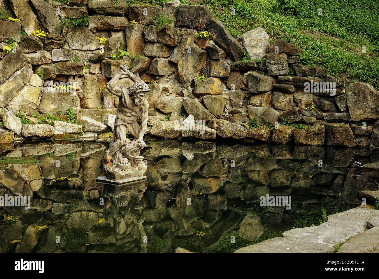 Hercules statue and a live duck in a pond, Kinsky Garden, Prague Stock