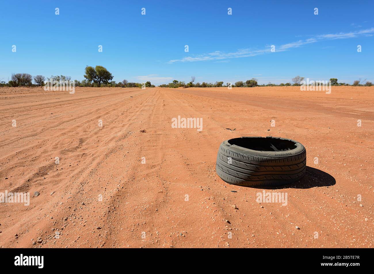Burst tyre left of an Australian Outback dirt road, Northern Territory, NT, Australia Stock Photo
