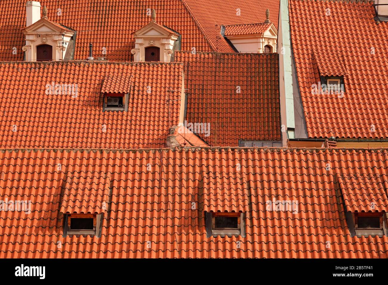 A sea of undulating red terracotta roof tiles and dormer windows & Waldstein Palace seen from the lookout in Fürstenberg Garden, Malá Strana, Prague Stock Photo
