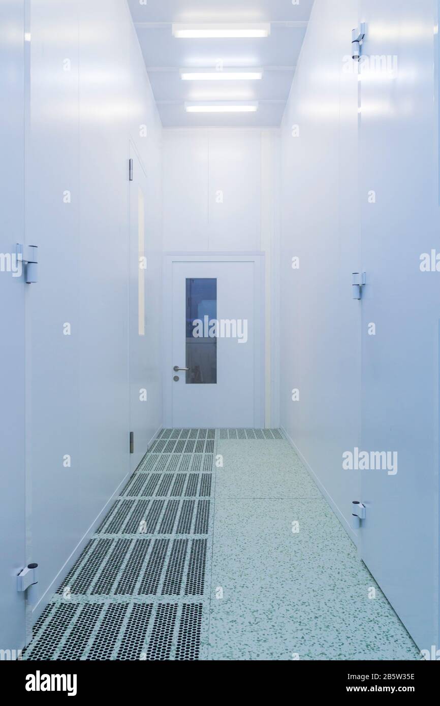 Inside white sterile clean room .Hallway with raised floor and door in