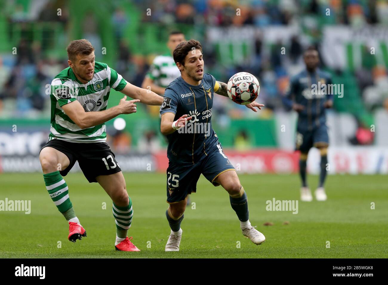 Lisbon. 8th Mar, 2020. Stefan Ristovski (L) of Sporting CP vies with Afonso Figueiredo of Desportivo das Aves during the Portuguese First League soccer match between Sporting CP and Desportivo das Aves in Lisbon, Portugal on March 8, 2020. Credit: Pedro Fiuza/Xinhua/Alamy Live News Stock Photo