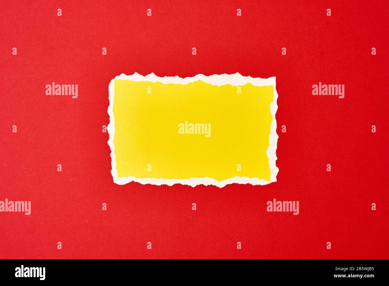 Ripped yellow paper torn edge sheet on red background. Template with ...