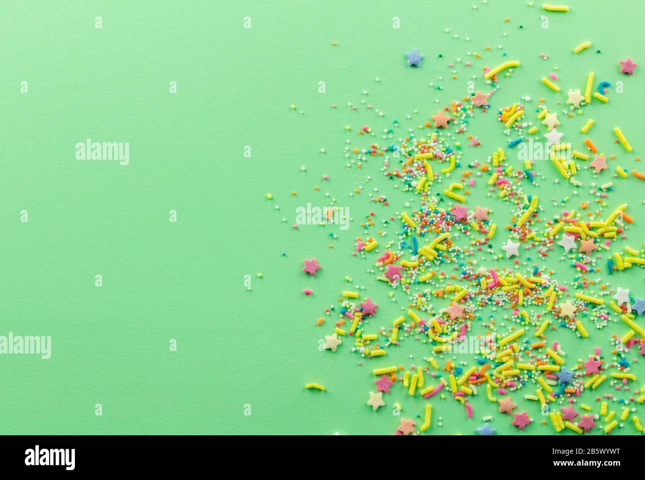 Sprinkle background with multicolored cake topping sprinkles scattered