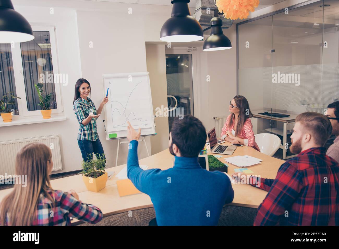 Presenting Woman presenting idea colleagues hi-res stock photography and images ...
