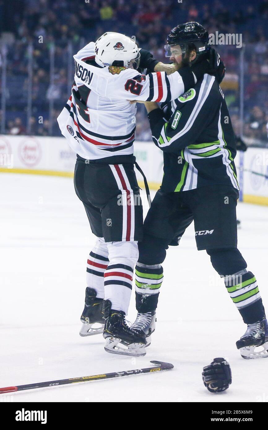 Chicago Wolves defenseman Brett Lernout (8) and Rockford IceHogs right wing Reese Johnson (24) fight during the second period during an AHL Illinois Lottery Cup game, Sunday, March 8, 2020, in Rosemont,