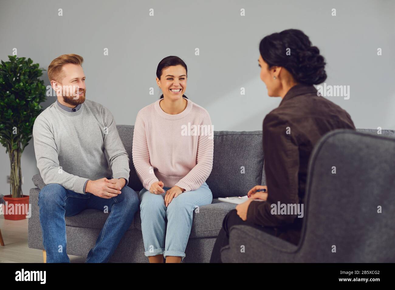 Family psychologist. Female psychologist at a psychotherapy session with family in the office. Stock Photo