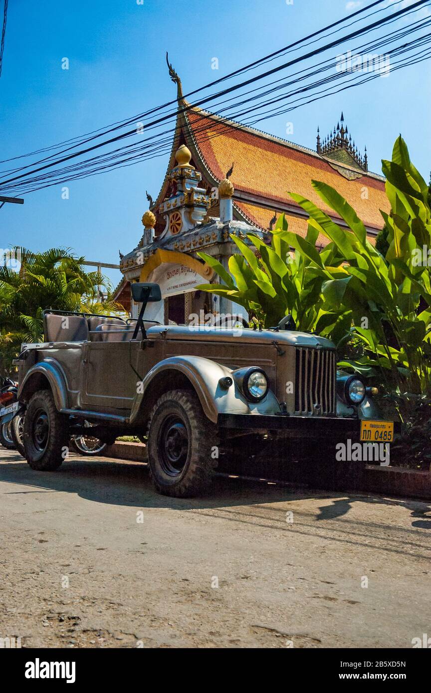 An old Soviet GAZ-69 jeep in front of Wat Nong Sikhounmuang, Luang Prabang, Laos. Stock Photo