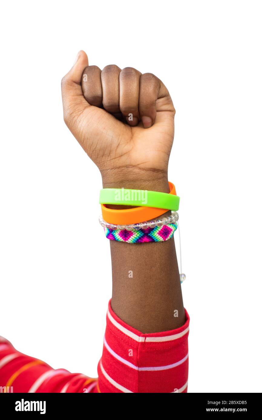 Close Up Of Teenage Girl Wearing Wristbands Raising Arm In Air To Depict Empowerment Stock Photo