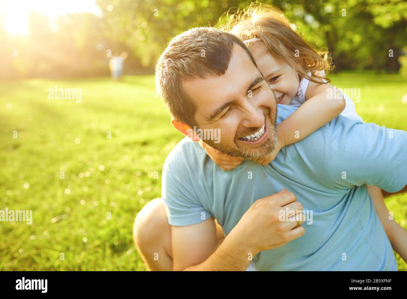 Father's day. Father plays with his daughter in the summer park. Stock Photo