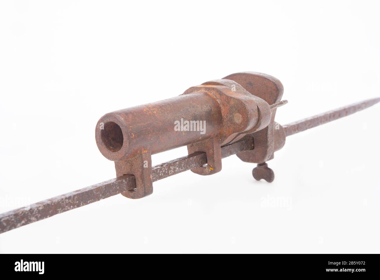 An old, metal alarm gun used for deterring poachers. The gun could be  loaded with a shotgun cartridge and was fired by a trip wire. The loud bang  woul Stock Photo 