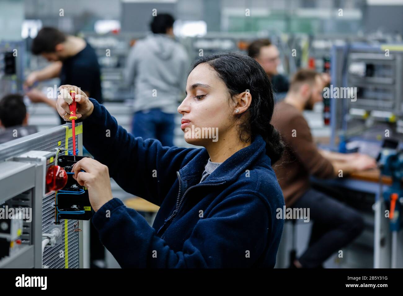 Remscheid, North Rhine-Westphalia, Germany - Trainee woman in electrical professions, an industrial electrician assembles a circuit, vocational traini Stock Photo