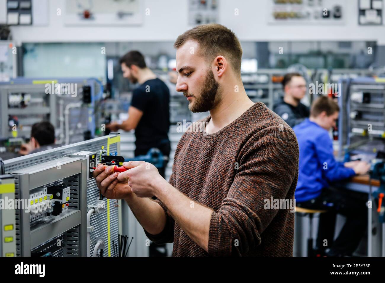 Remscheid, North Rhine-Westphalia, Germany - Trainee in electrical professions, an industrial electrician assembles a circuit, vocational training cen Stock Photo