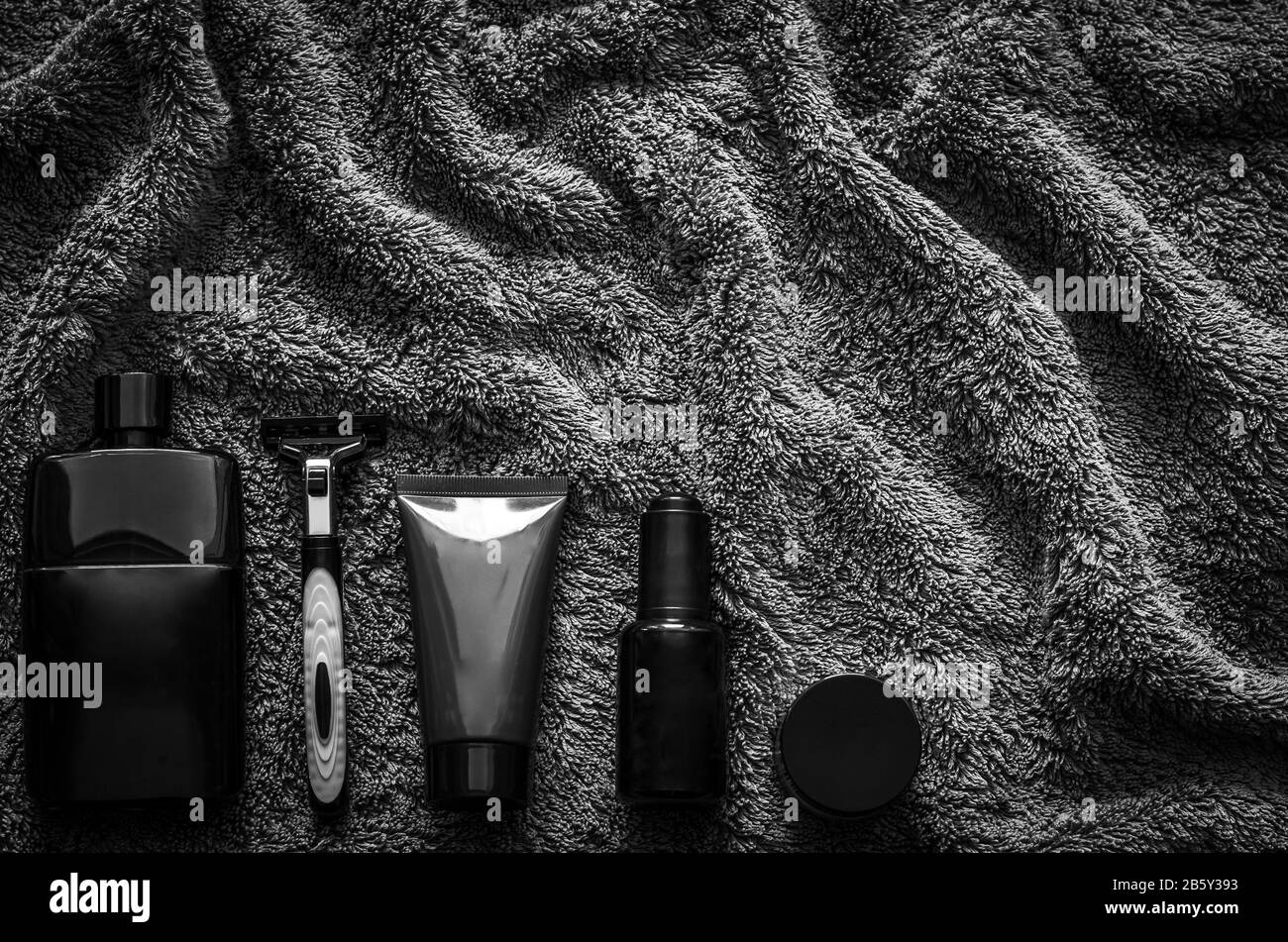 Men toiletries in modern lifestyle on dark towel background for