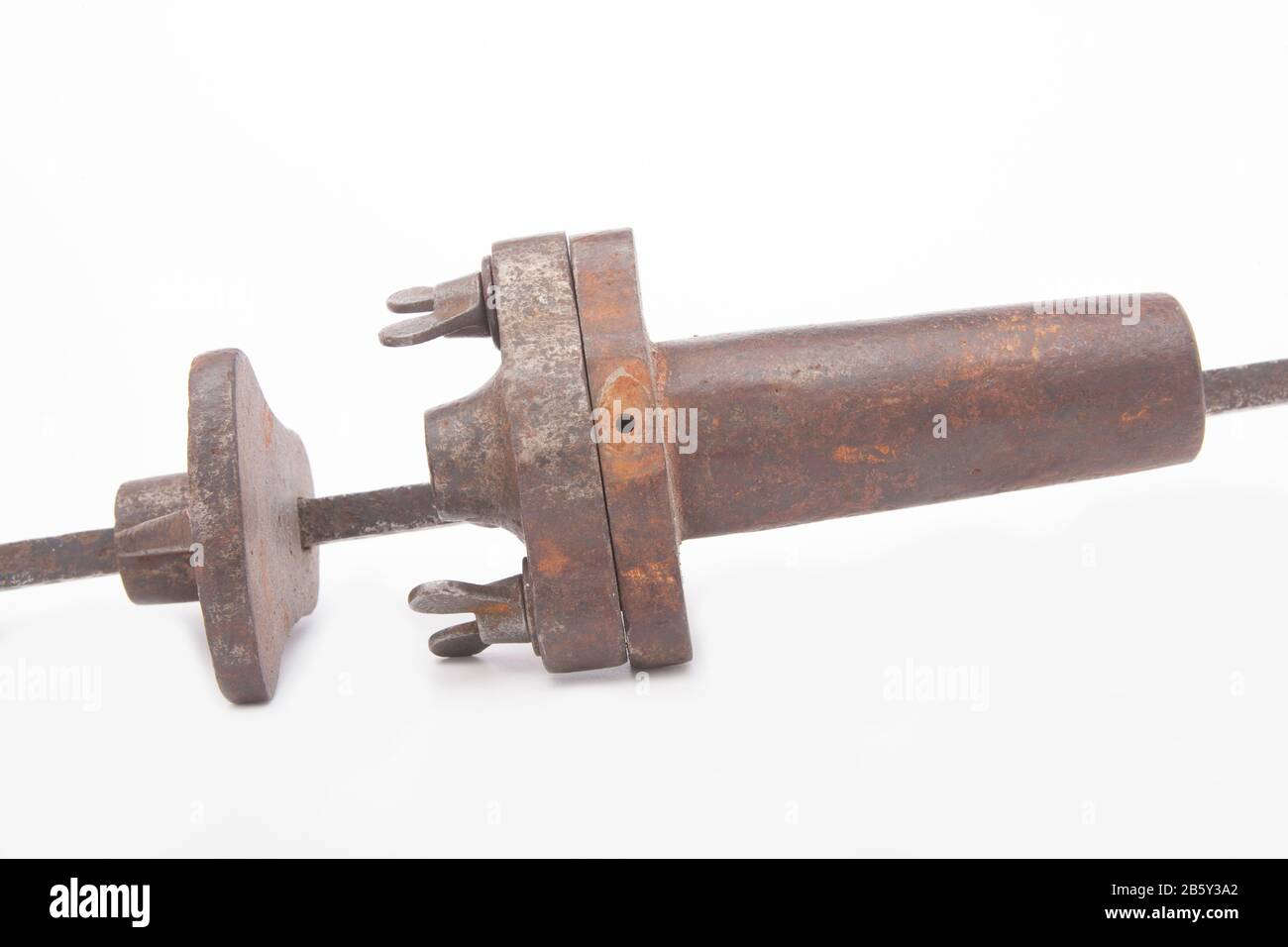 An old, metal alarm gun used for deterring poachers. The gun could be loaded with a shotgun cartridge and was fired by a trip wire. The loud bang woul Stock Photo
