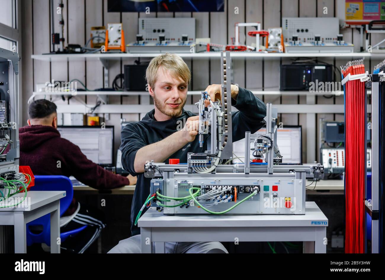 Remscheid, North Rhine-Westphalia, Germany - Trainees in metal and electrical professions, an industrial mechanic assembles an electro-pneumatic syste Stock Photo