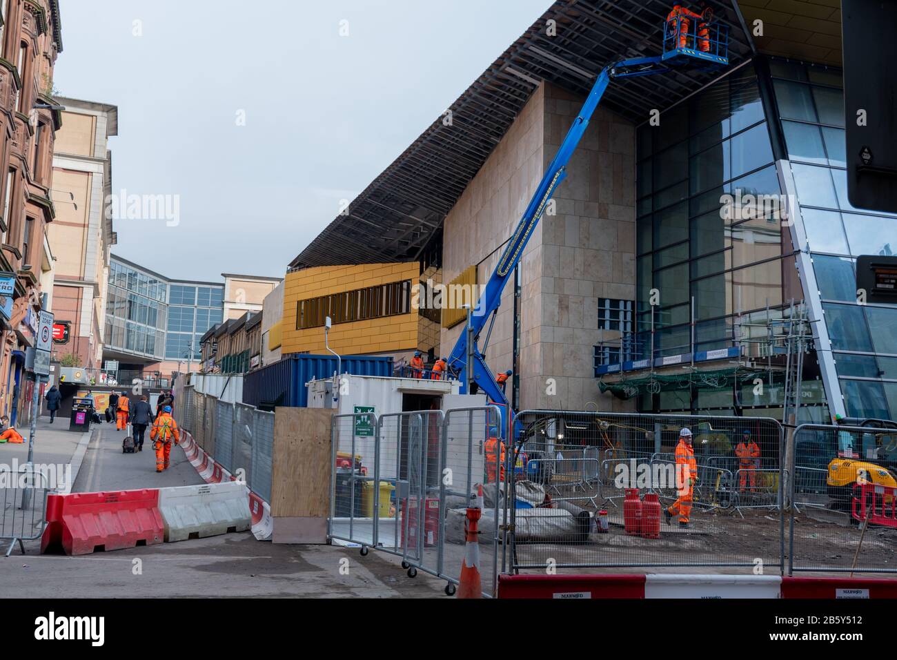 Construction workers at work on the refurbishment of Queen Street Train Station in March 2020 in Glasgow City Centre. Stock Photo