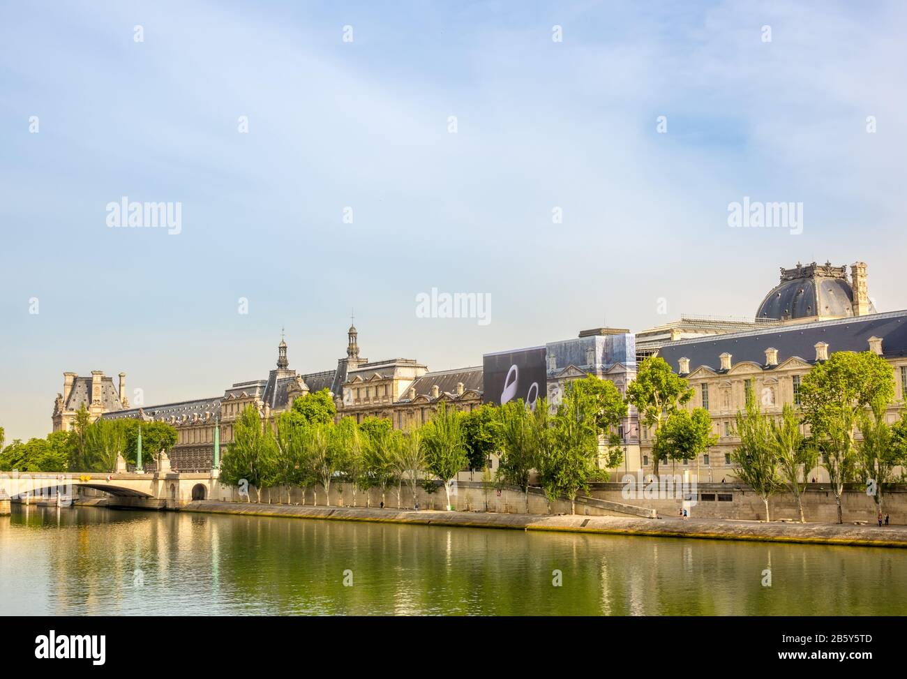 France. Summer sunny day in Paris. Seine River Embankment and the Louvre Museum Façade Stock Photo