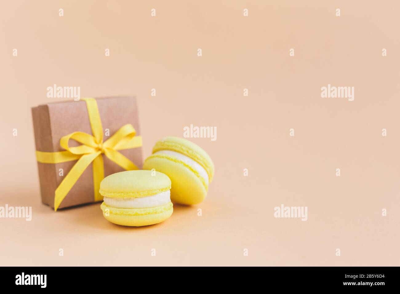 Yellow Macarons With Gift Box On A Peach Pastel Background Lemon Macarons Place For Text Stock Photo Alamy