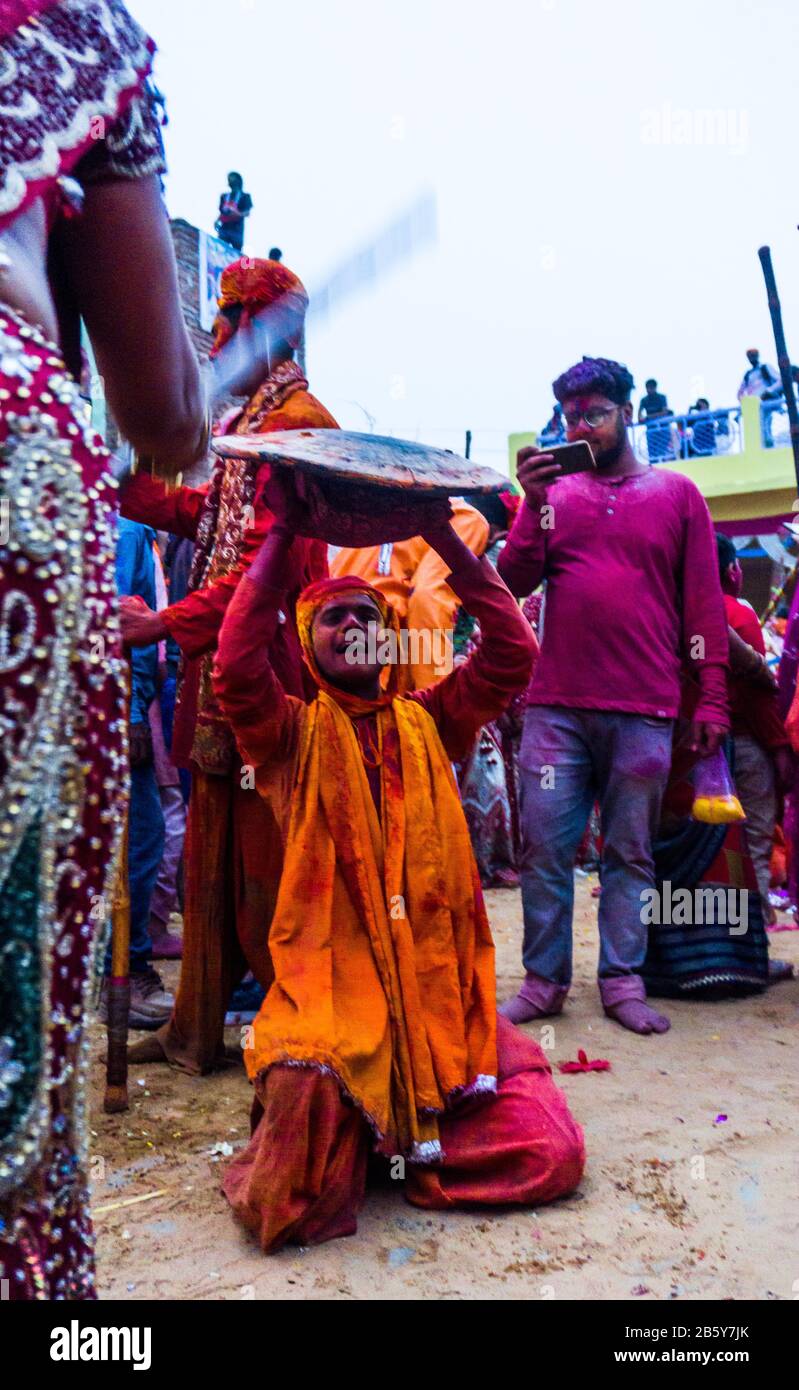 People celebrating lathmar holi in nand gaon Stock Photo