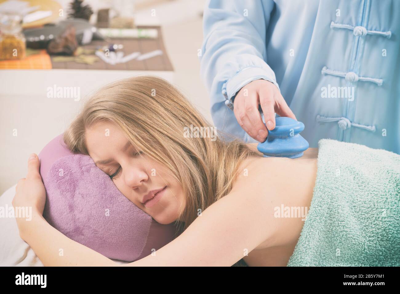 Therapist doing traditional chinese cupping therapy on her patient