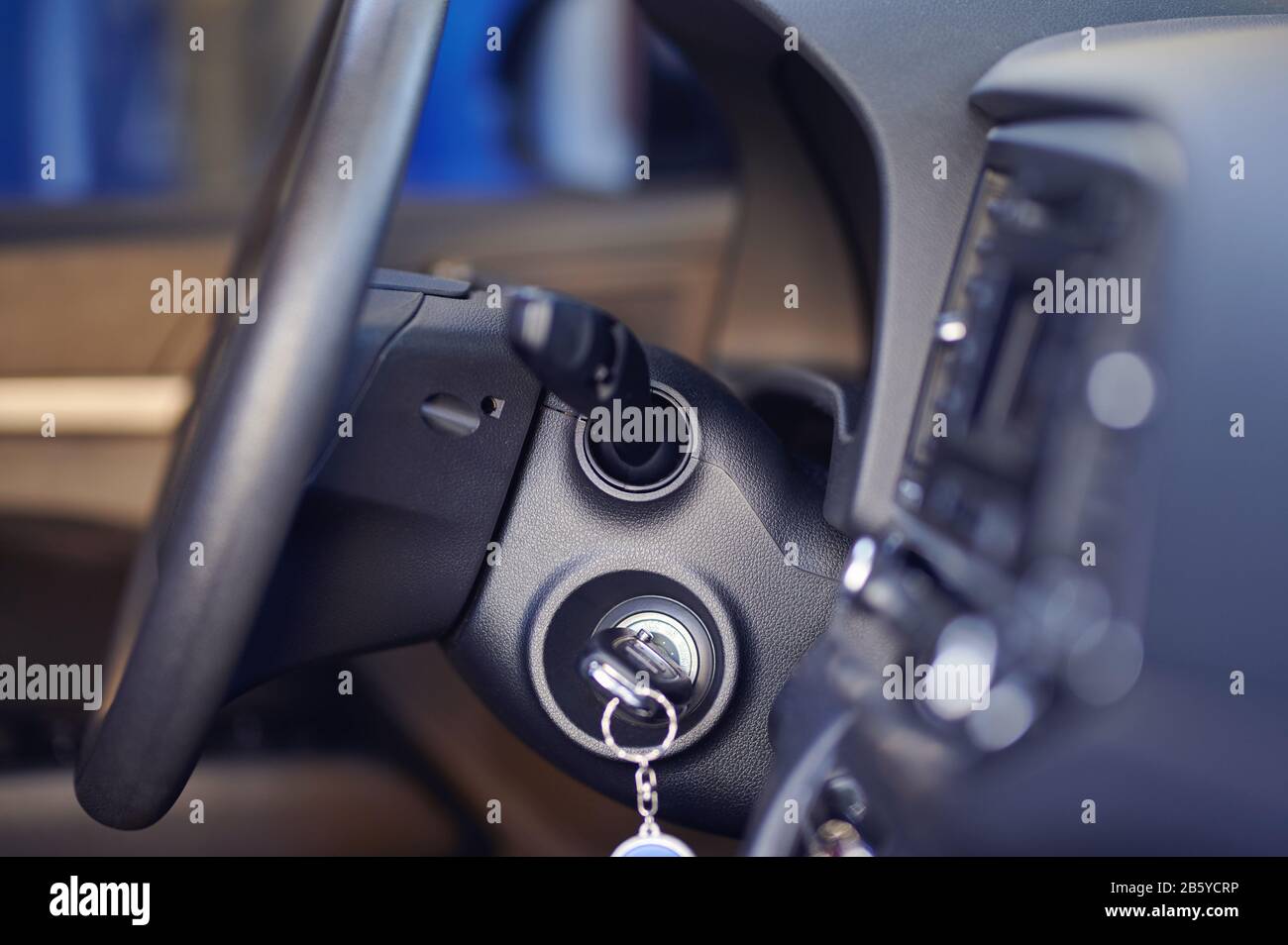 Key in car ignition with steering wheel side view Stock Photo Alamy
