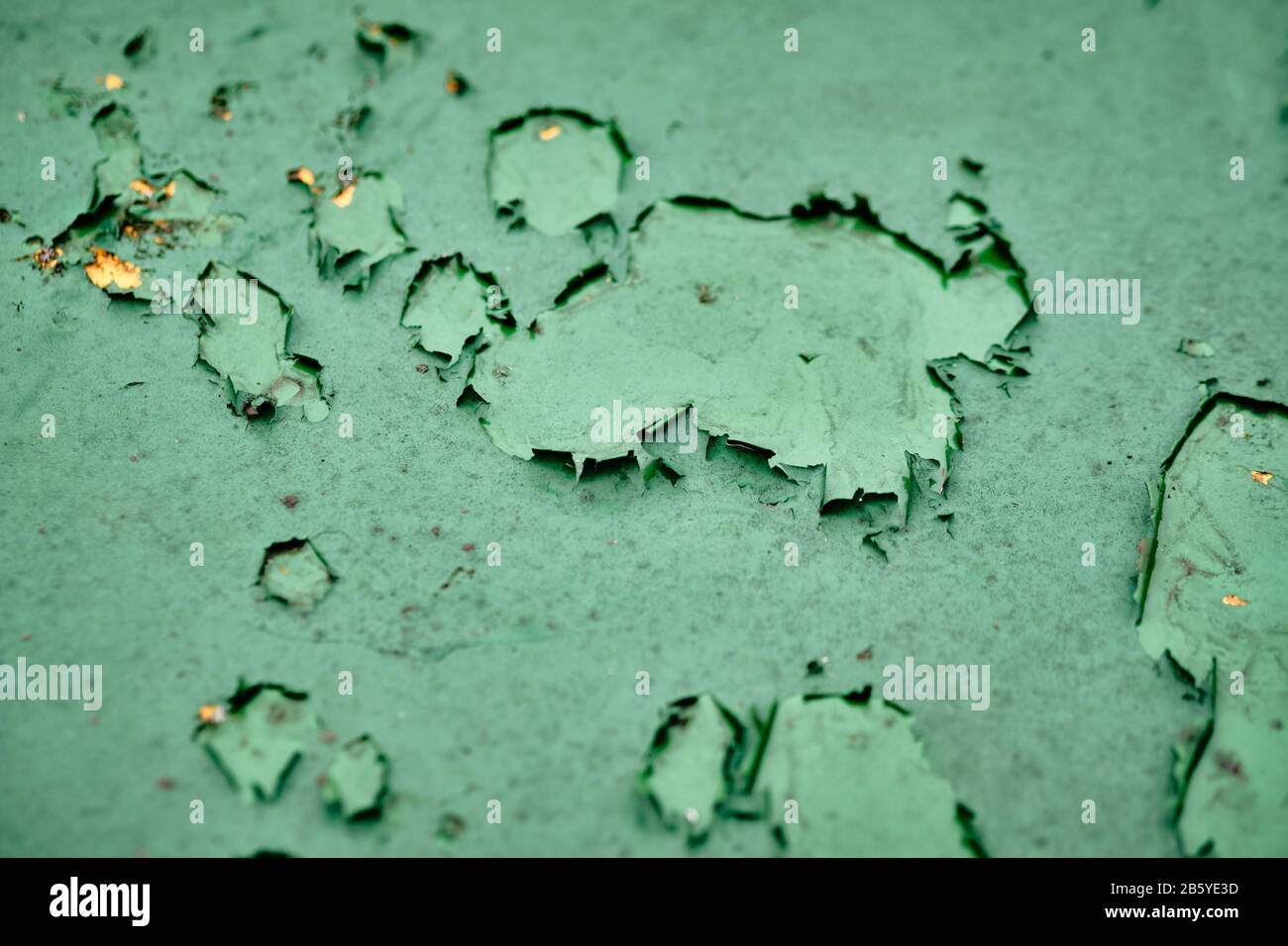 Close-up of a weathered green moody background with the paint flaking off Stock Photo