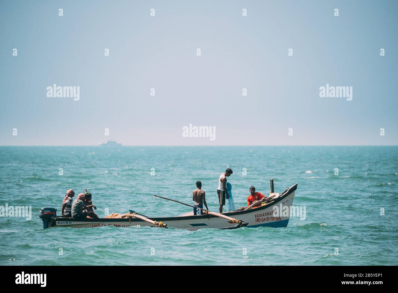 Goa, India February 10, 2020 Fishermen In Boat Pulling Fishing Net