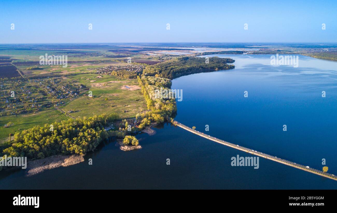 Aerial: Flying over a dam at spring land Stock Photo - Alamy