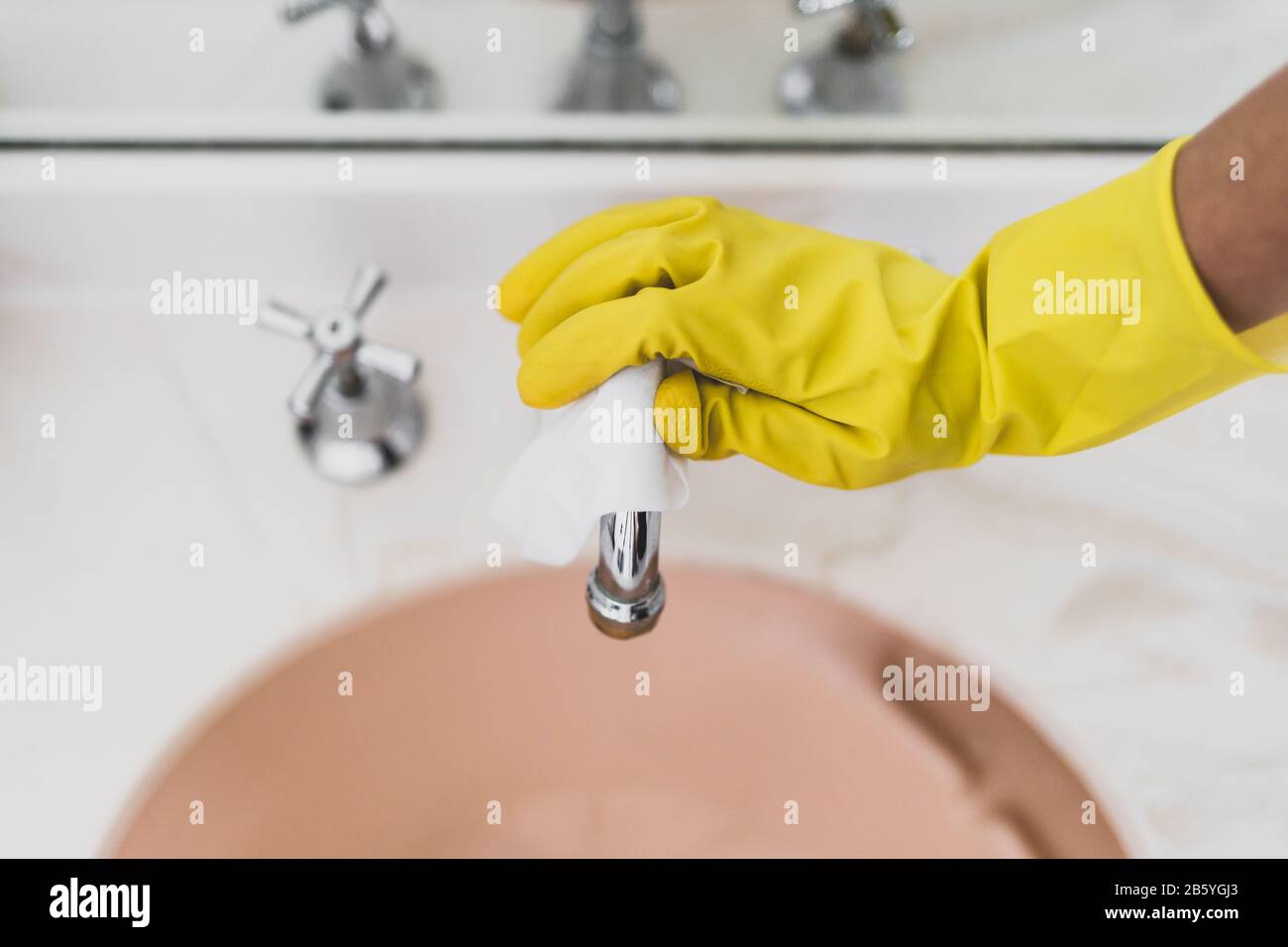 concept of disinfecting surfaces from bacteria or viruses silllife, hand with glove cleaning