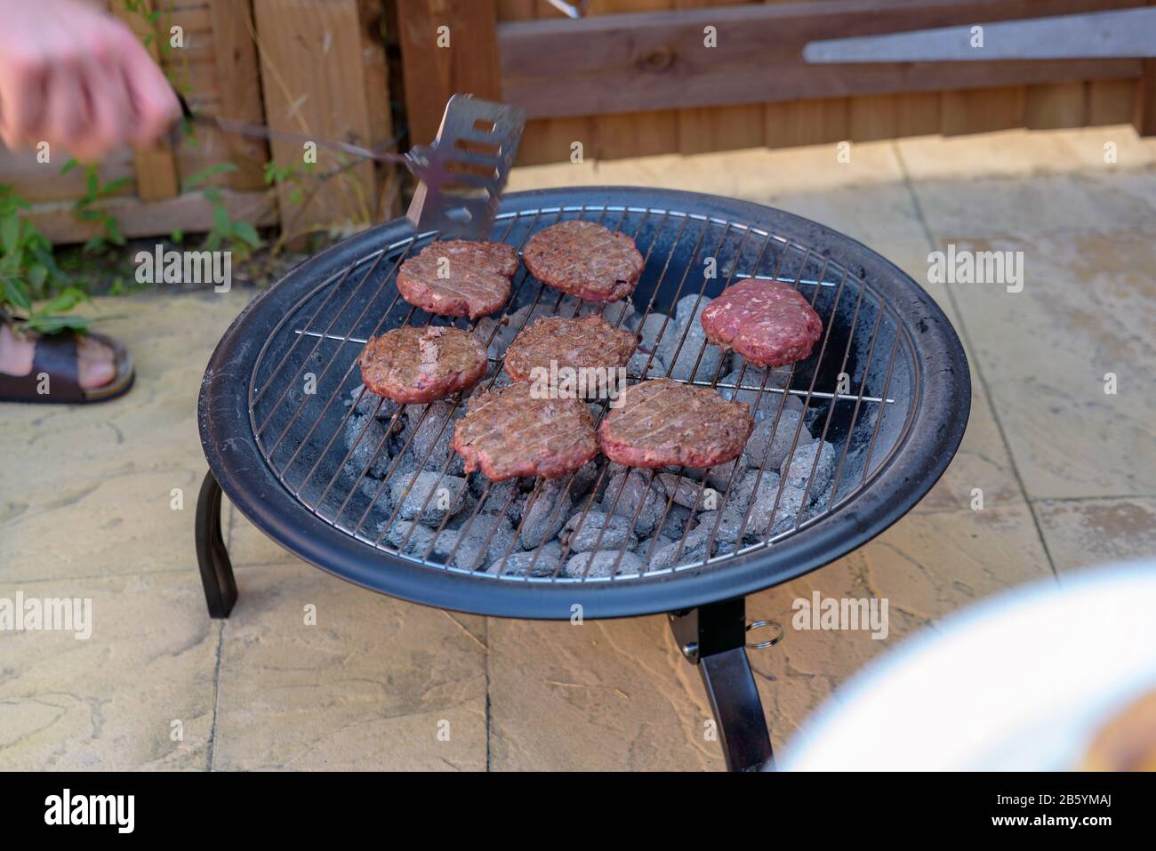 bbq grill handmade burgers cooking on hot charcoal in backyard in england  uk Stock Photo - Alamy