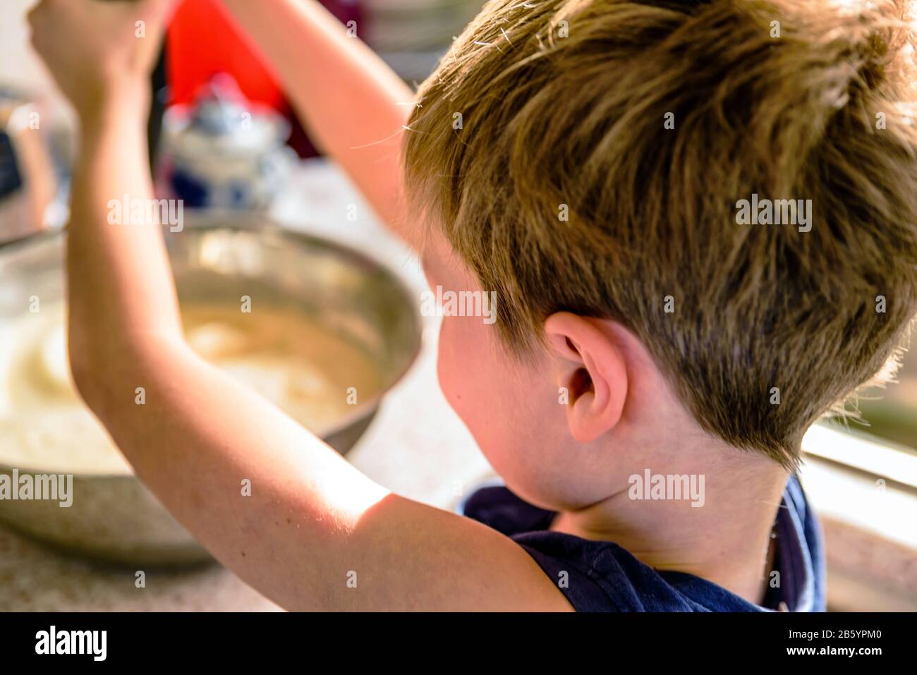 child boy making pancake mix with blender in kitchen Stock Photo Alamy
