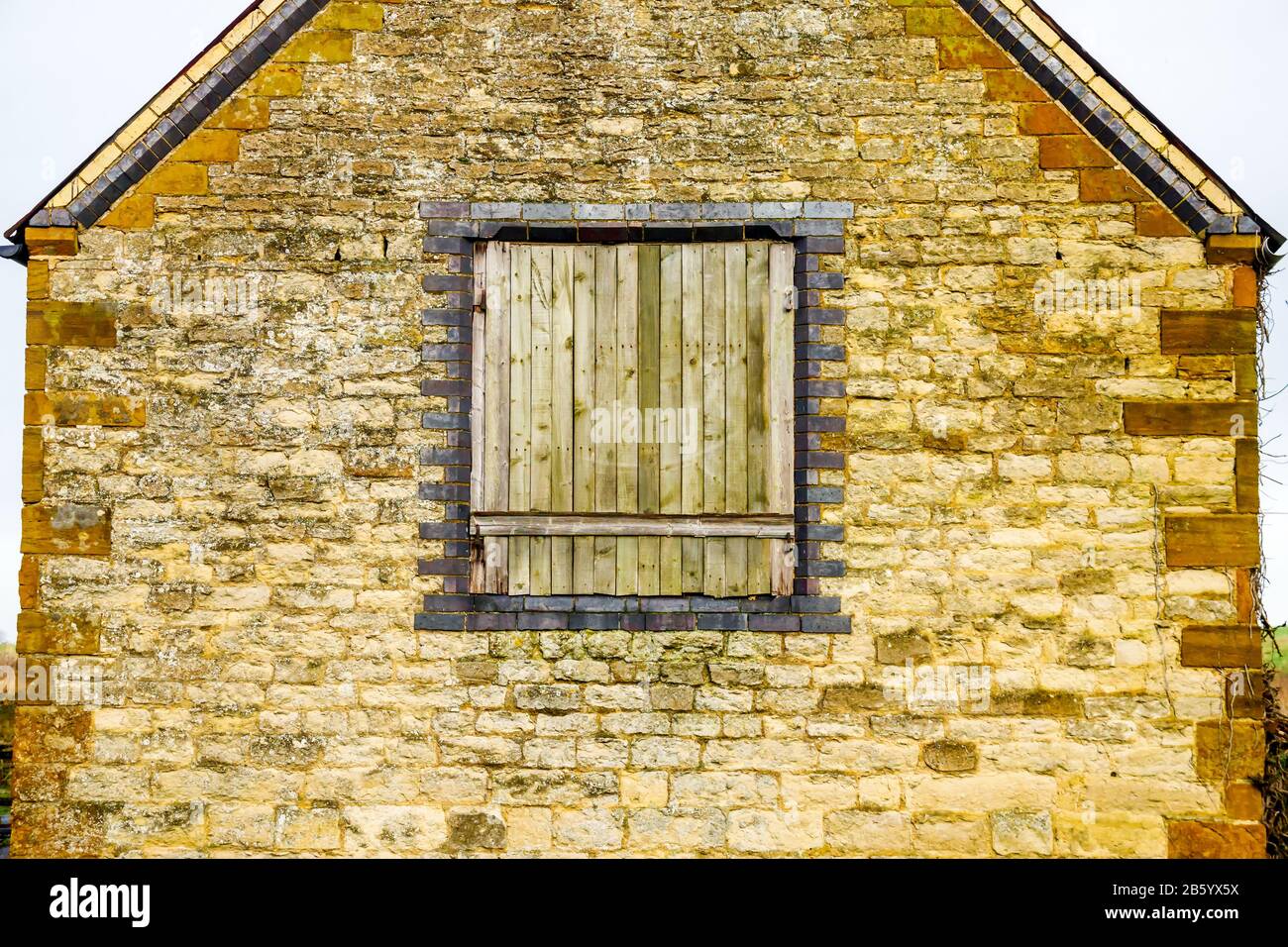 old window on stone wall building texture in england uk Stock Photo - Alamy