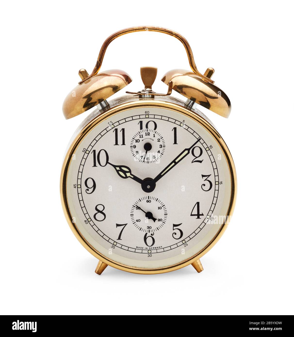 Old fashioned mechanical alarm clock with bells on top with hands at eight minutes past ten Stock Photo