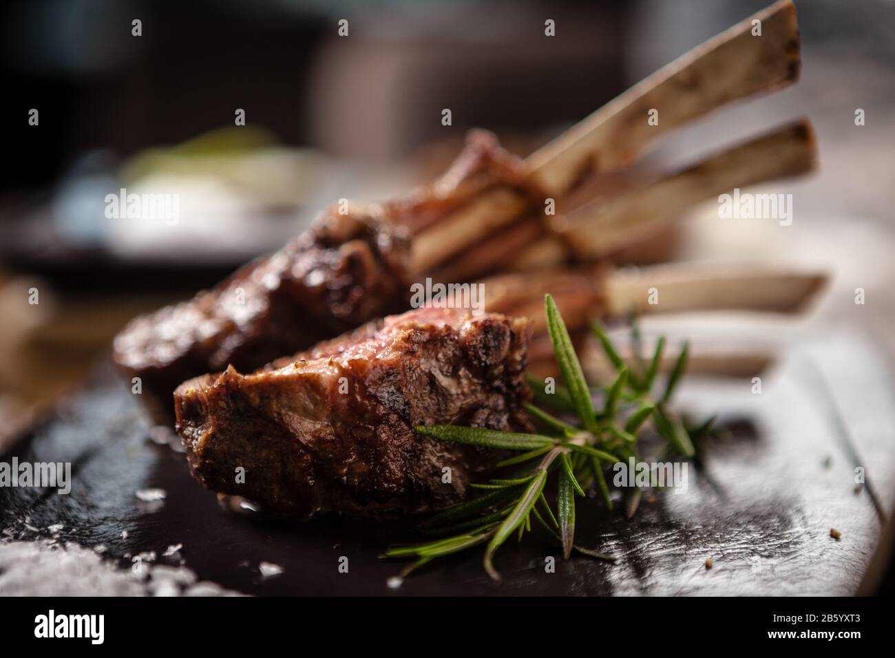 Grilled lamb chops served with a branch of rosemary Stock Photo - Alamy