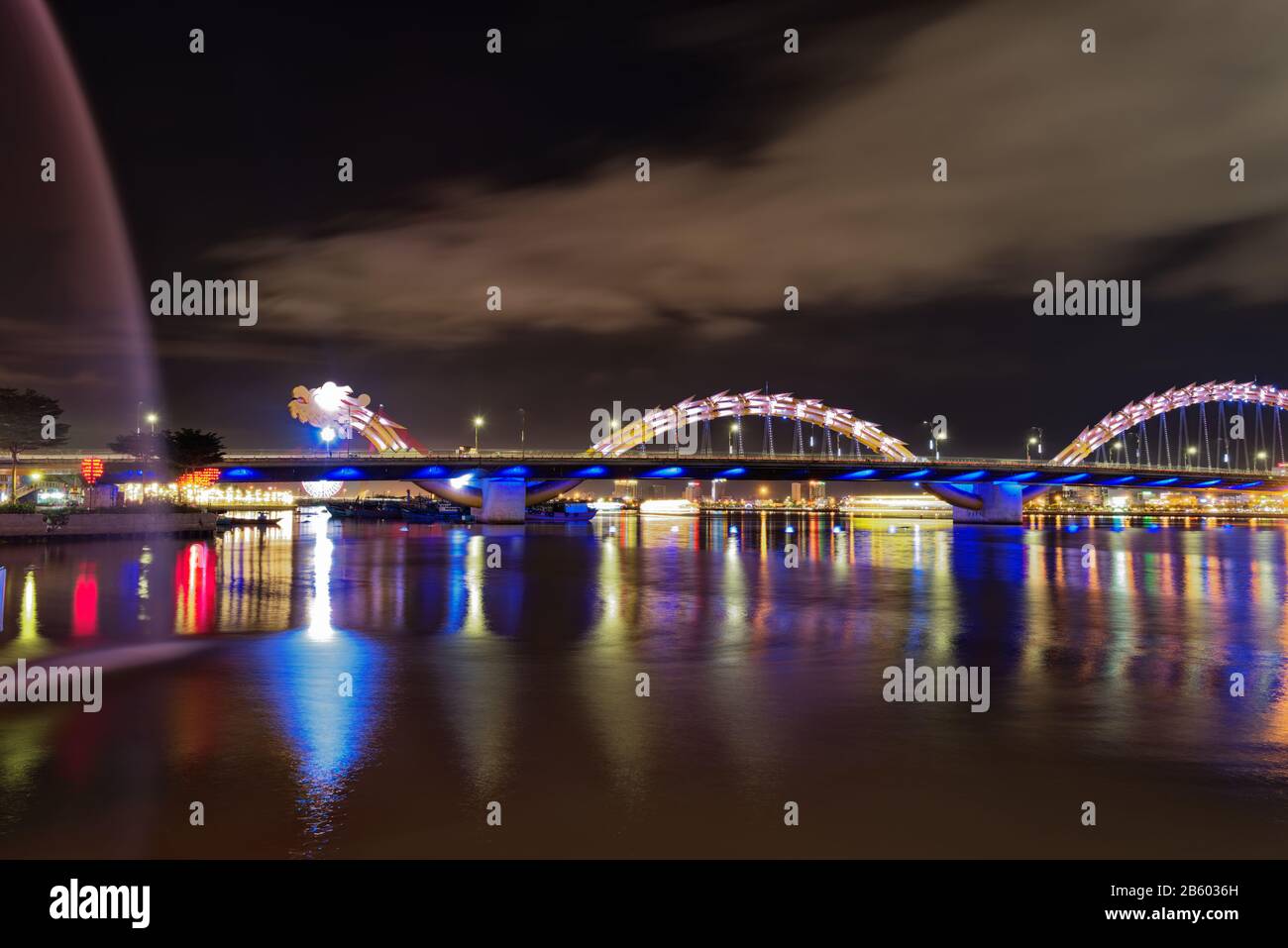Panoramic view of illuminated Dragon bridge at night, all lit up. Da Nang, Vietnam Stock Photo