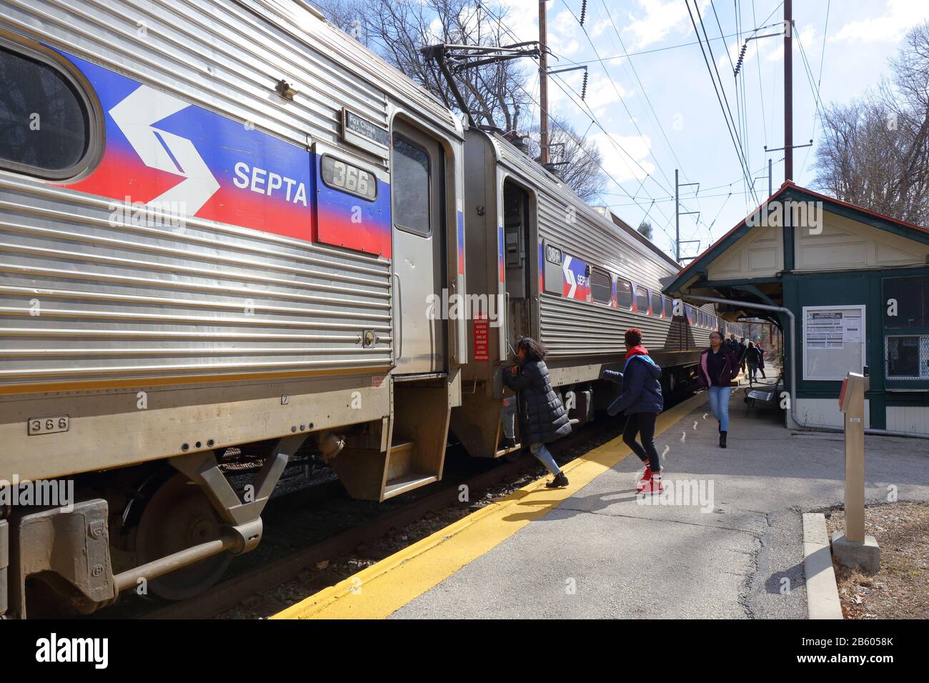 People boarding a SEPTA Chestnut Hill West Line commuter train at Upsal station in Northwest Philly, Philadelphia, PA. February 29, 2020 Stock Photo