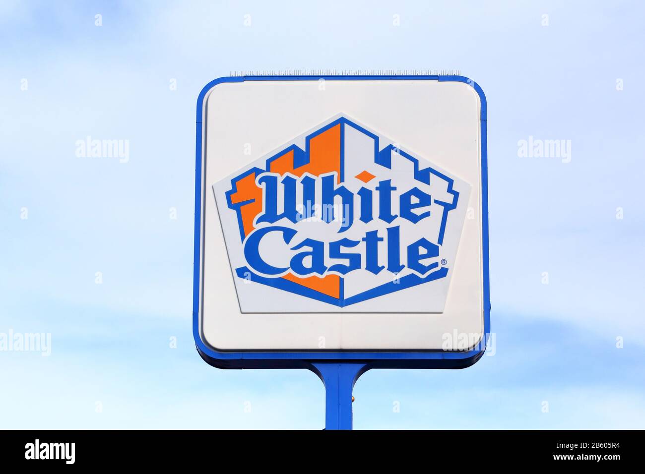 A White Castle sign on a pole against a blue sky. Stock Photo