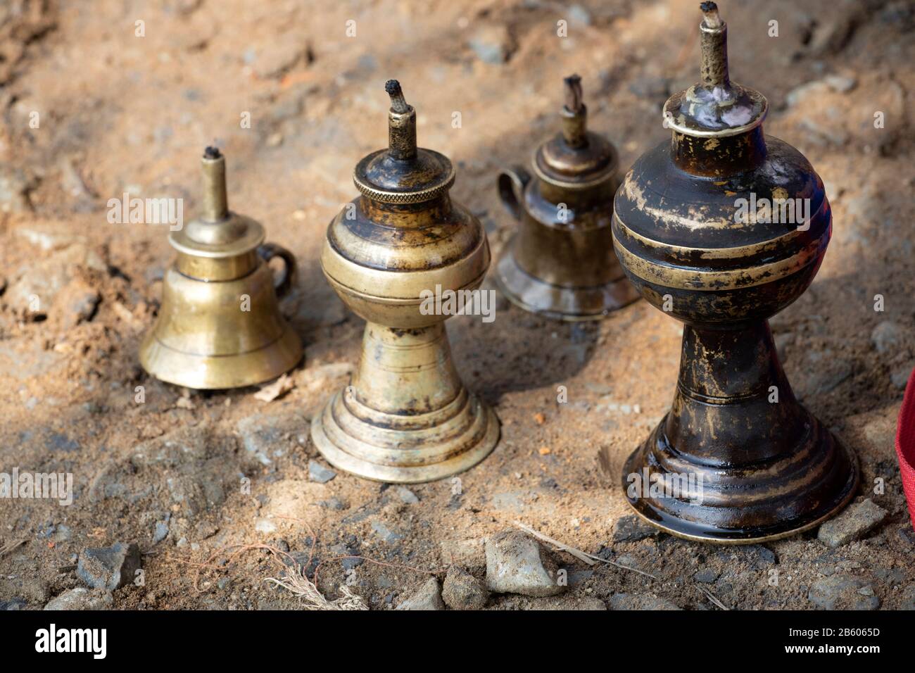 a collection of antique brass kerosene or oil lamps used in the country